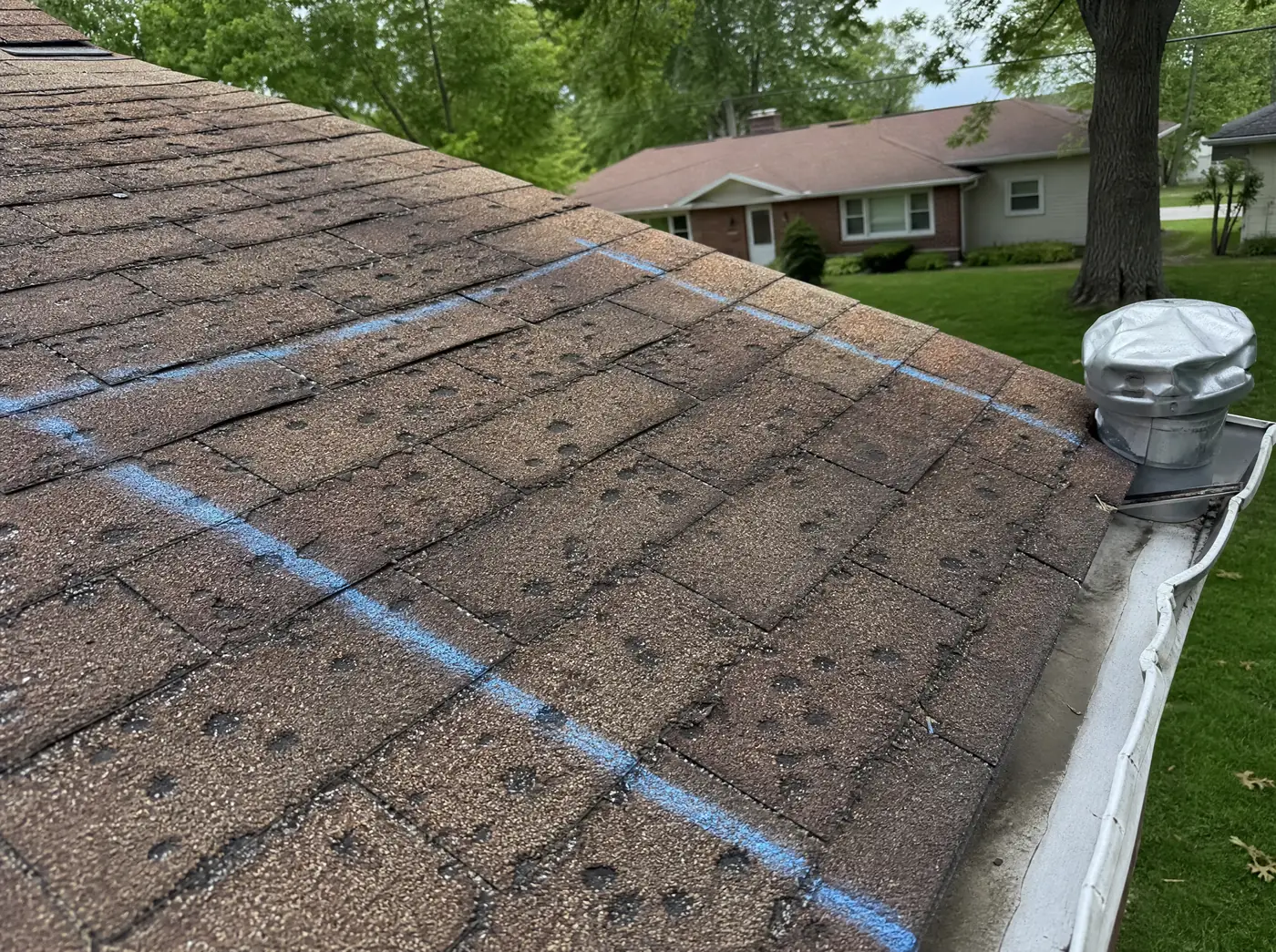 Hail damaged asphalt shingle roof in northwest Springfield MO before replacement