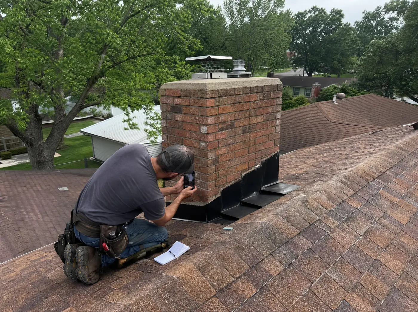 Roof inspector photographing shingle condition on a Springfield MO roof