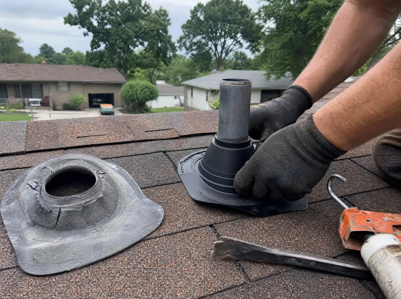 Roofer replacing a cracked pipe boot flashing on a Springfield Missouri roof