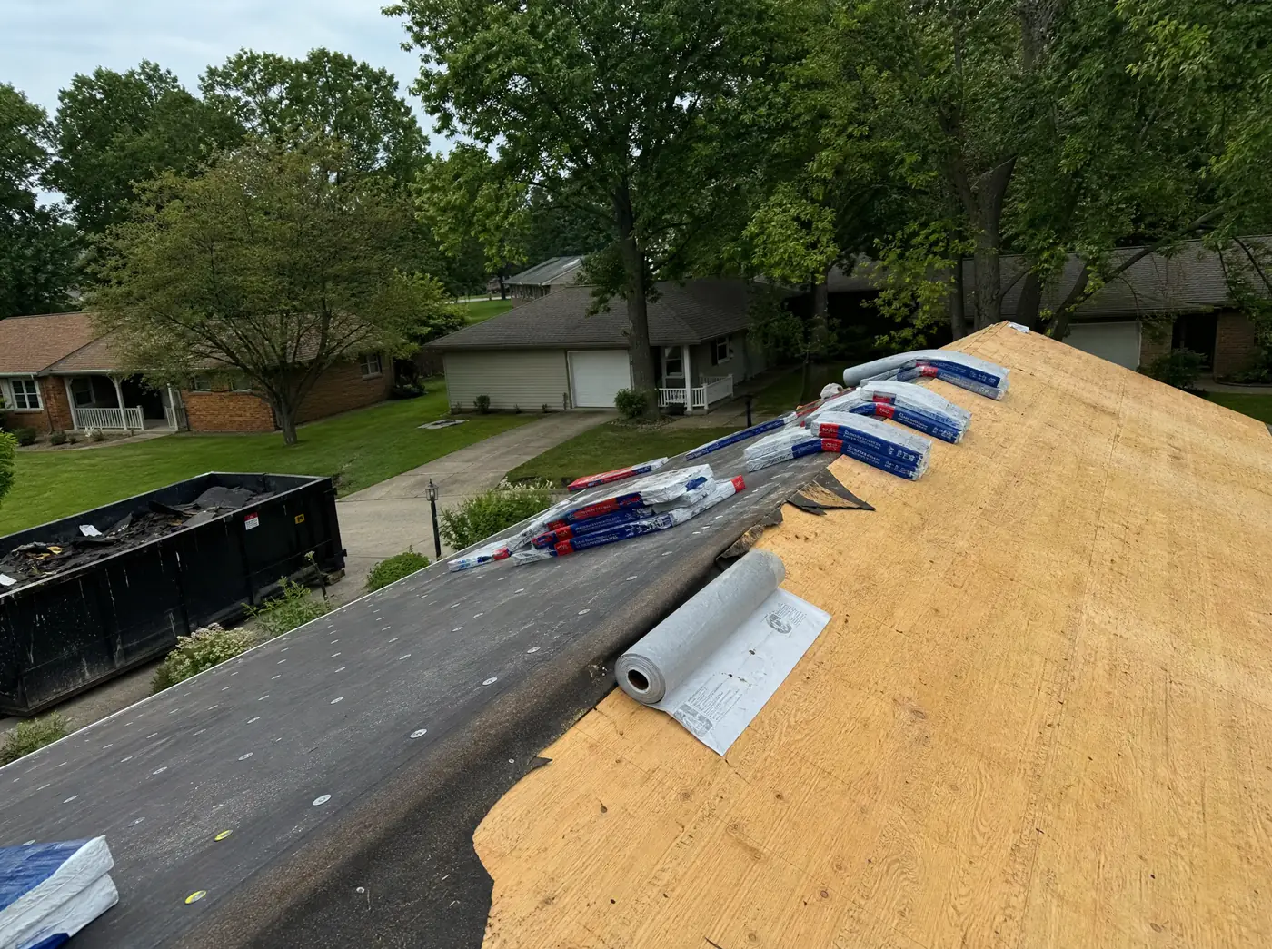 Bundles of architectural shingles staged on a Springfield MO roof mid-replacement