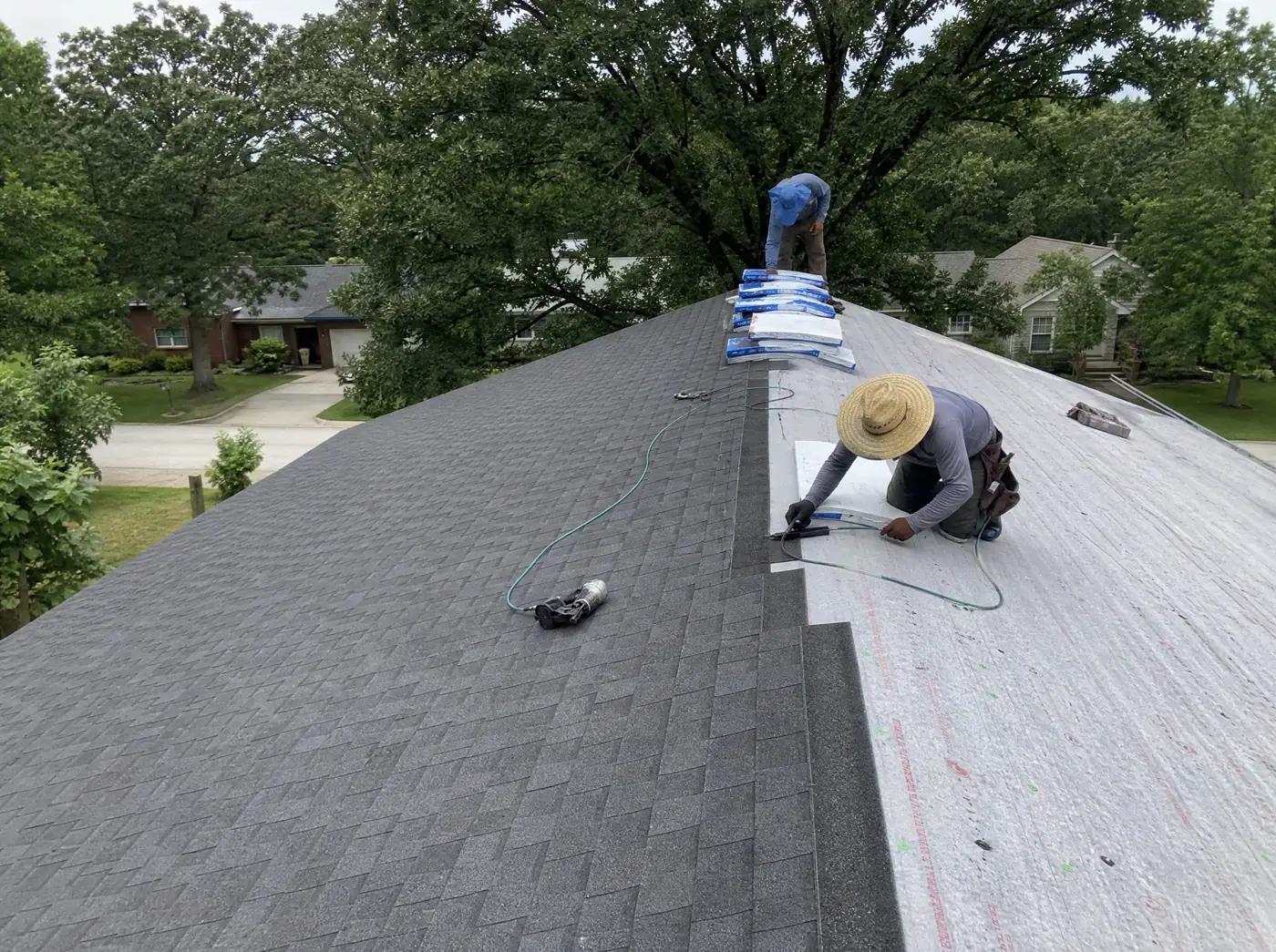 Roof replacement crew installing architectural shingles on a Springfield MO home