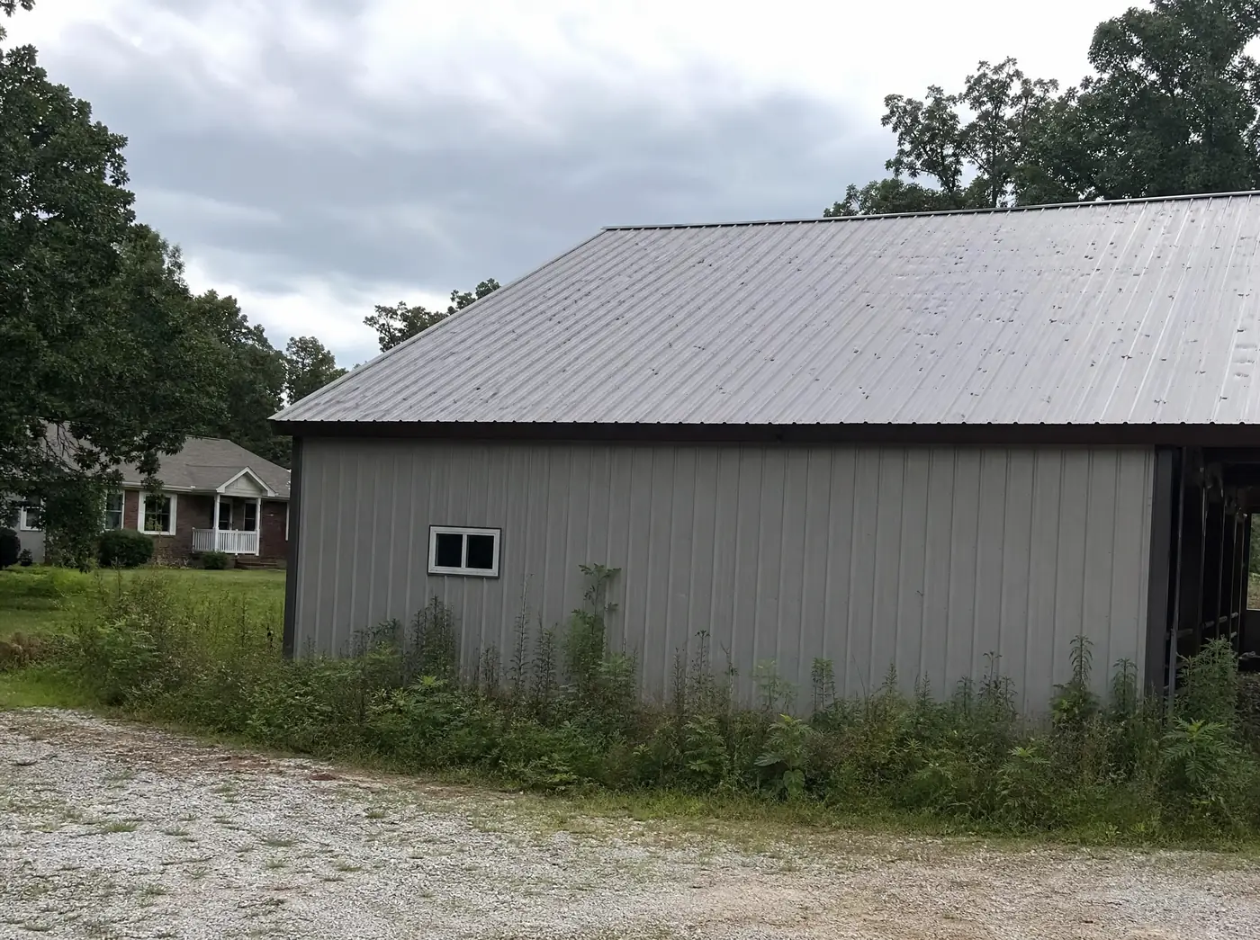 Farmhouse and outbuilding roofs damaged by giant hail near Ash Grove MO