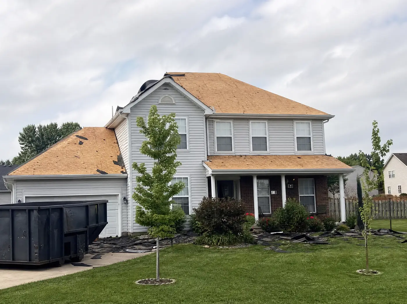 Storm-damaged asphalt shingle roof on a Republic MO subdivision home